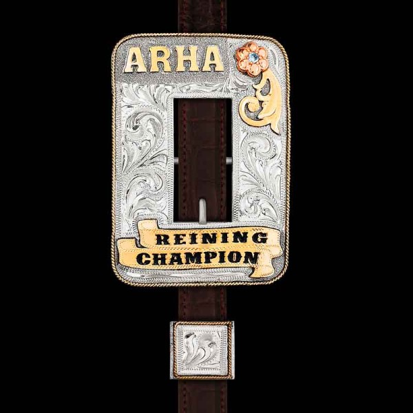 Our Arabian Headstall is handcrafted on a German Silver base featuring a traditional Jeweler's Bronze rope edge, two banners on the lower portion of the buckle, a Copper flower with scrollwork overlay, and your choice of cubic zirconia stone. Make it your